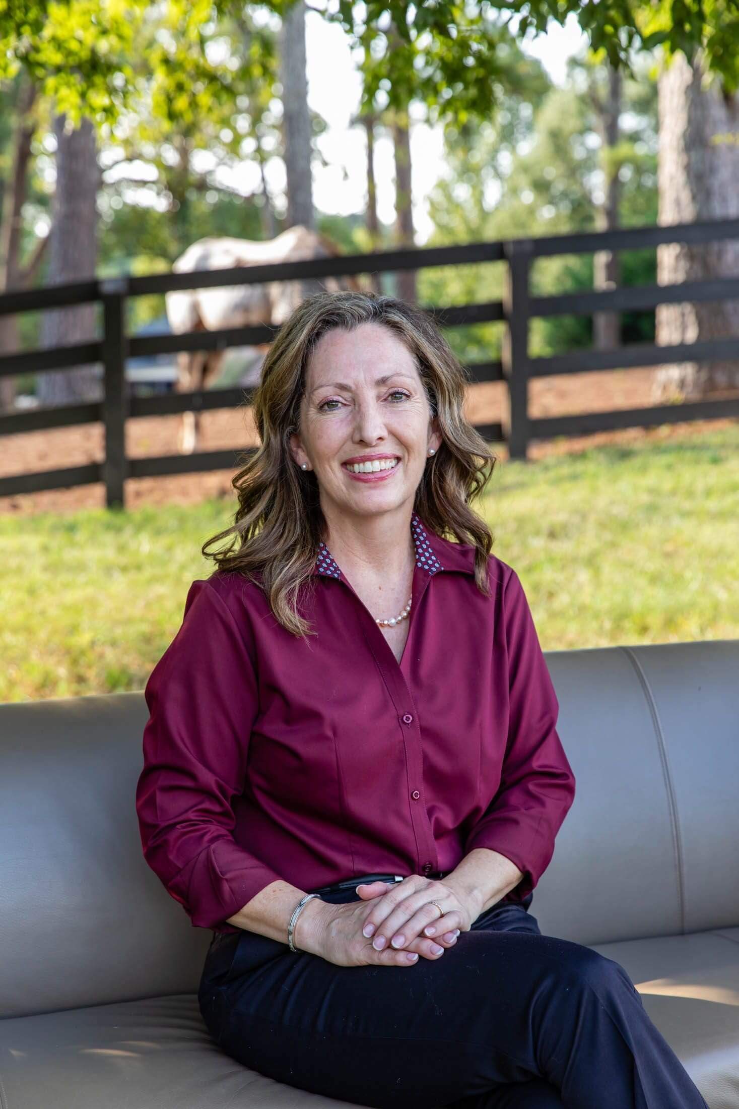Woman sitting outdoors on a couch.